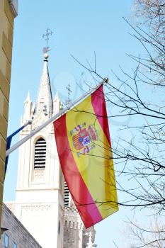 The flag of Spain flying from a building in Madrid