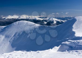View from the top of the snow-capped mountain range. Ukraine, Dragobrat ski resort, Carpathian mountains.