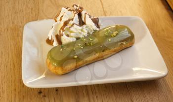 pistachio choux pastry on white plate