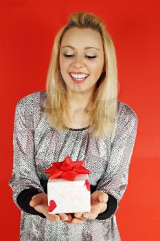 Beautiful long-haired woman holding a gift box