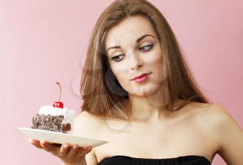 Beautiful woman holding a piece of chocolate cake