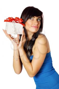 Beautiful long-haired woman listens to the gift box
