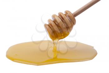 Honey dripping from a wooden spoon.