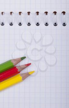 Royalty Free Photo of a Notebook and Pencil Crayons