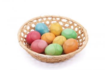 Easter painted eggs in a basket, isolated on white.