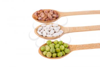 Beans and green peas in a spoon on a white background.