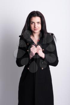 Beautiful brunette in a black coat.