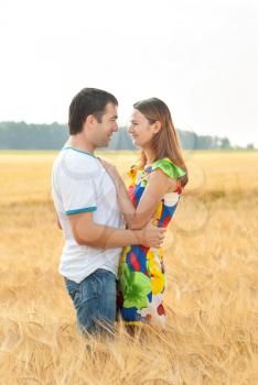 Attractive young couple hugging outdoors.