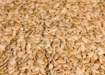 Close up of organic pumkin seeds / kernels. Background.