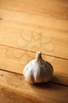 White raw garlic on wooden plank desk background