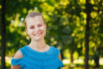 Closeup Portrait Of Beautiful Young Girl In Blue Knitted Dress In The Park Outdoor