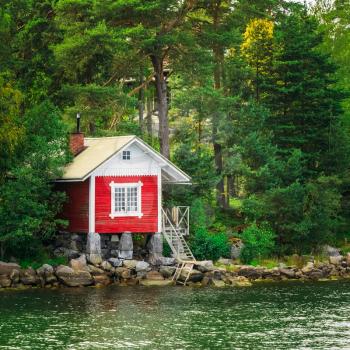 Red Finnish Wooden Sauna Log Cabin On Island In Summer