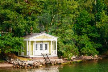 Yellow Finnish Wooden Sauna Log Cabin On Island In Summer