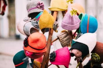 Close View Of Various Colorful Traditional European Caps Hats At Winter Christmas Market. Souvenir From Europe.