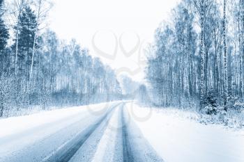 Snow-covered Open Road During A Snowstorm In Winter. Adverse Weather Conditions. Toned Filtered Photo