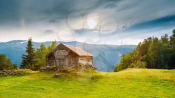 Old abandoned wooden house on a background of the Norwegian mountains. Summer nature Norway. Panoramic view
