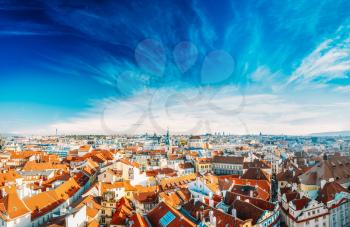 Cityscape of Prague, Czech Republic. View from viewpoint on old hall tower. Old houses under blue sunny sky.