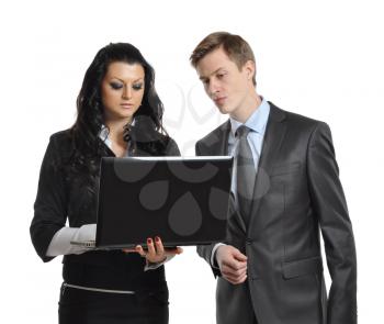 business people man and woman looking with interest at a laptop. isolated on white