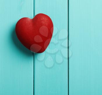 red heart on a blue wooden background