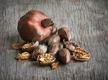 pomegranate and pecan nuts on a wooden table