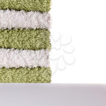 A pile of green and white towels