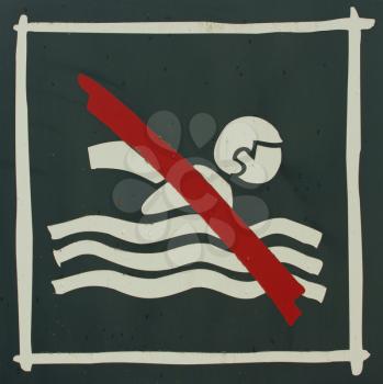 A close-up of a no swimming sign