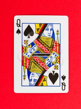 Old playing card (queen) isolated on a red background