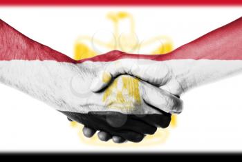 Man and woman shaking hands, wrapped in flag pattern, Egypt