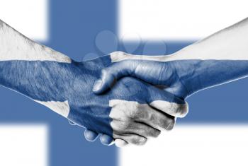 Man and woman shaking hands, wrapped in flag pattern, Finland