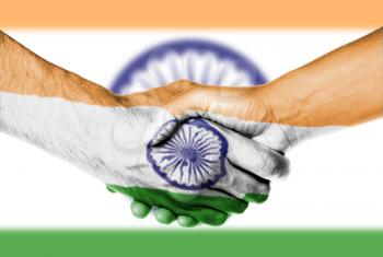 Man and woman shaking hands, wrapped in flag pattern, India