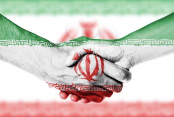 Man and woman shaking hands, wrapped in flag pattern, Iran