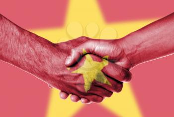 Man and woman shaking hands, wrapped in flag pattern, Vietnam