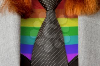 Close-up of a caucasian business woman with a tie,rainbow flag pattern