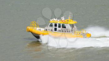 ROTTERDAM, THE NETHERLANDS - JUNE 22: Yellow Crewtender at high speed in the harbor of Rotterdam (Holland), Rotterdam, June 22, 2012