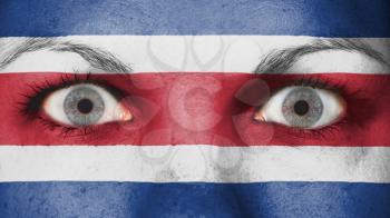 Close up of eyes. Painted face with flag of Costa Rica