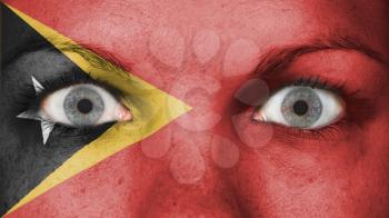 Close up of eyes. Painted face with flag of East Timor