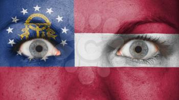 Close up of eyes. Painted face with flag of Georgia