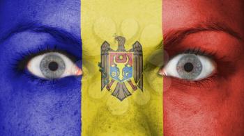Close up of eyes. Painted face with flag of Moldova