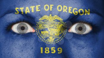 Close up of eyes. Painted face with flag of Oregon