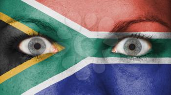 Close up of eyes. Painted face with flag of South Africa
