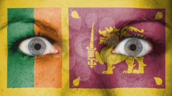 Close up of eyes. Painted face with flag of Sri Lanka