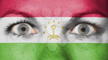 Close up of eyes. Painted face with flag of Tajikistan