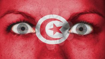 Close up of eyes. Painted face with flag of Tunisia