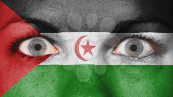 Close up of eyes. Painted face with flag of Western Sahara
