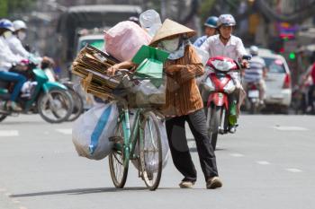 HUE, VIETNAM - JULY 25. Vietnamese woman packed her possesions on a bicycle and is fleeing for the coming Typhoon Vicente on July 25, Hue, Vietnam