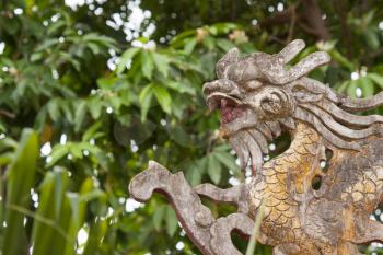 Chinese dragon ornament on a rooftop in the Vietnamese jungle
