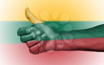 Old woman giving the thumbs up sign, isolated, flag of Lithuania