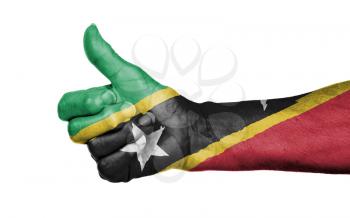 Old woman giving the thumbs up sign, isolated, flag of Saint Kitts and Nevis