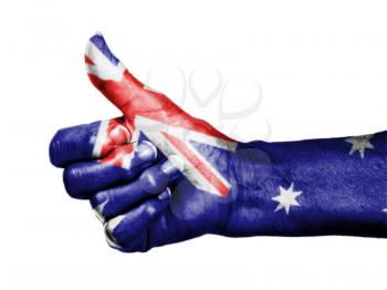 Old woman with arthritis giving the thumbs up sign, wrapped in flag pattern, Australia