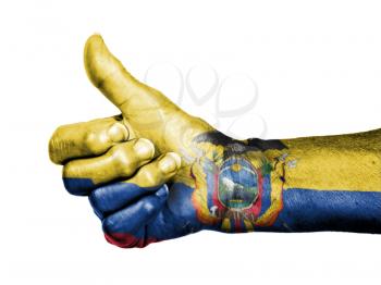 Old woman with arthritis giving the thumbs up sign, wrapped in flag pattern, Ecuador